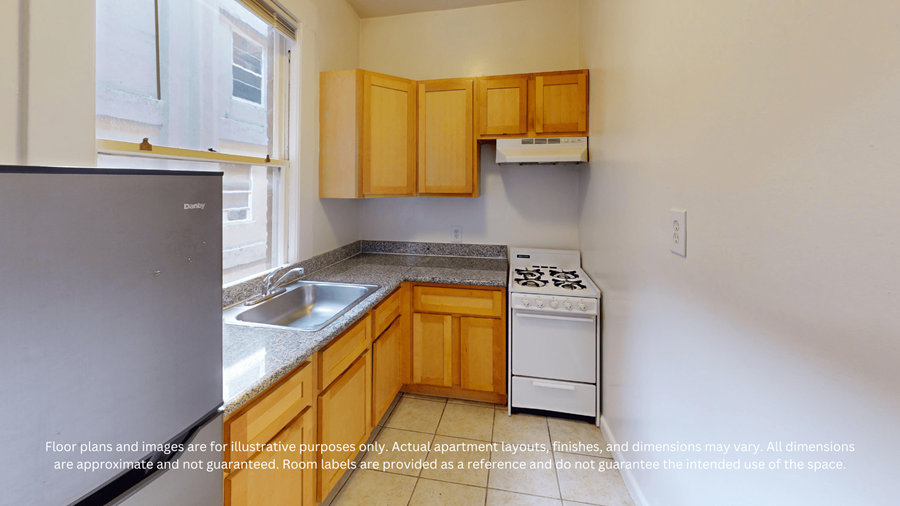 A kitchen with wooden cabinets and a black refrigerator.